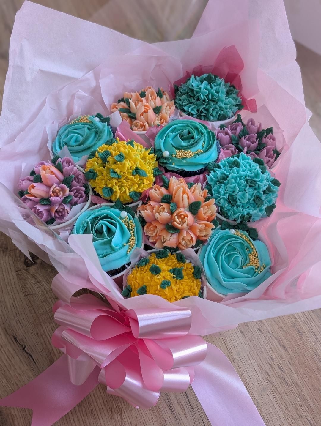 Pink cupcake bouquet arranged as a gift